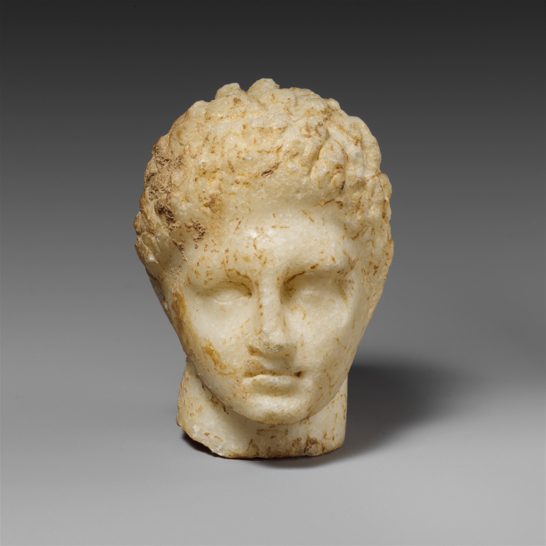 Weathered marble face, cropped to the eyes